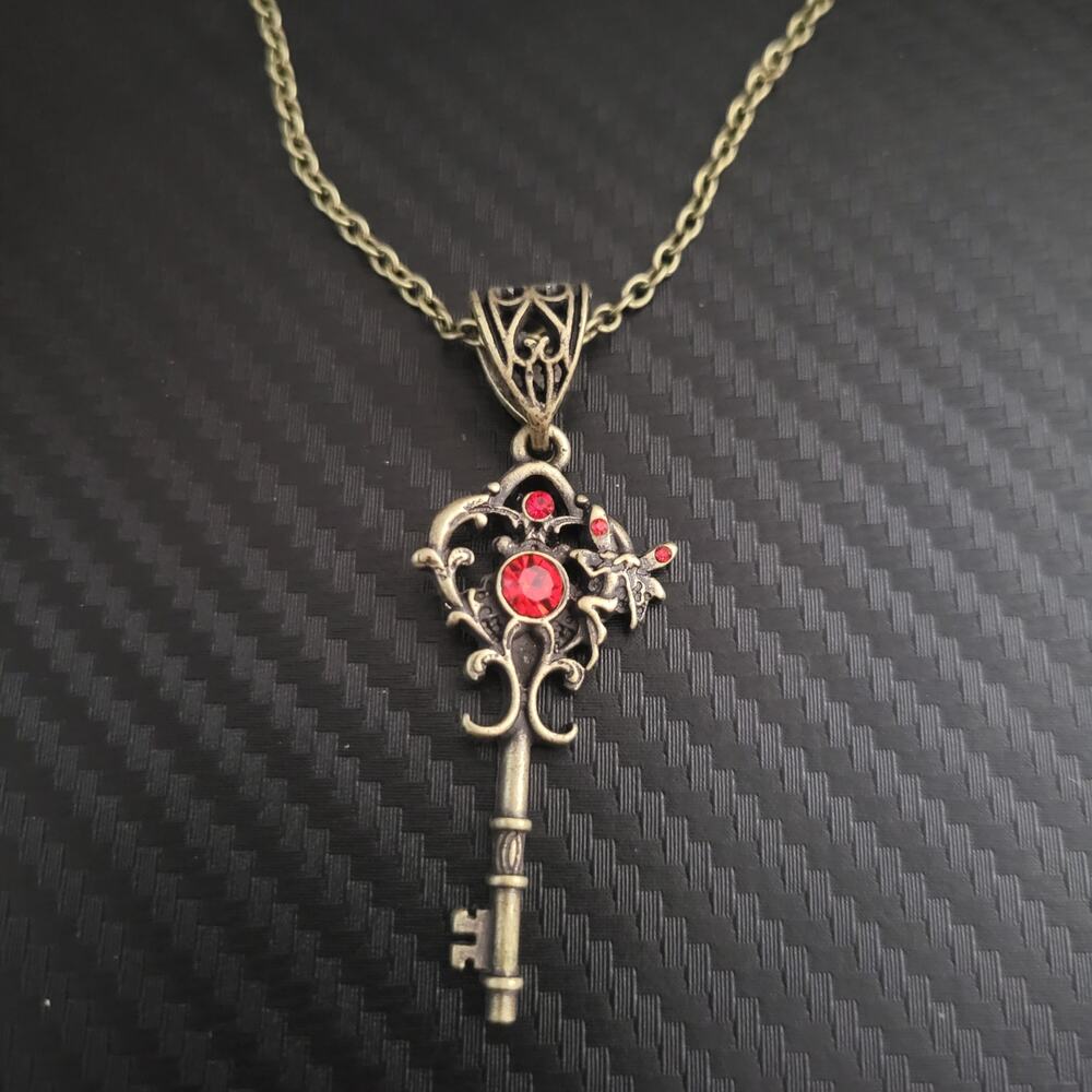 Fairy skeleton key necklace, bronze tone with red crystal